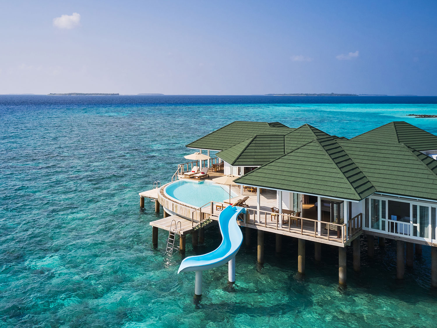 Example: "Overwater villa deck with steps into turquoise lagoon, Maldives"