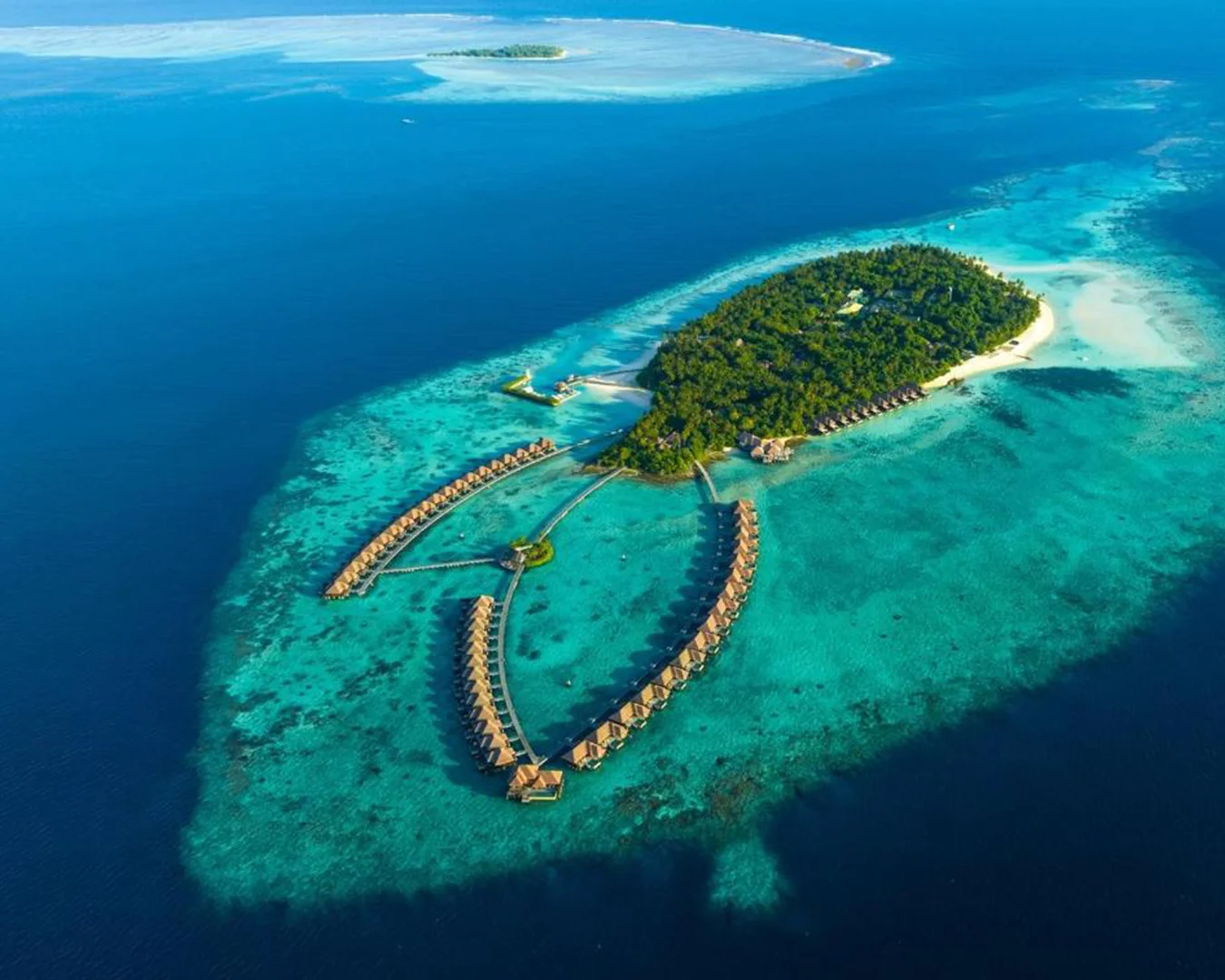 Aerial view of a Maldives island resort and turquoise lagoon
