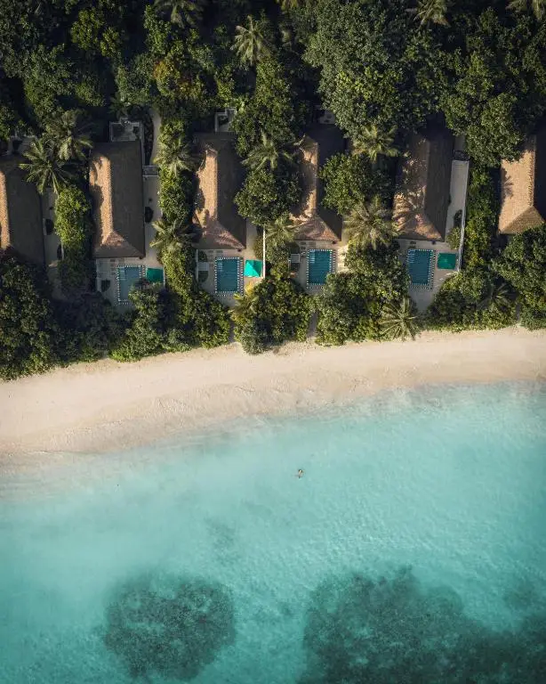 Aerial view of Finolhu's white-sand beach meeting the turquoise lagoon.